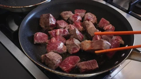 Sautéing beef in a skillet Stock Footage 201388035