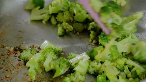 Sautéing Broccoli and Celery in a Skillet with Spatula at Cooking Stock-Footage 341462027