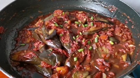 Sauteing Corned Beef with Slices of Eggplants in a Pan Stock Footage 241512332