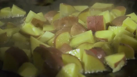 Sauteing Diced Apples In A Pan, Stirring With Wooden Spoon. close up Video stock 168790350