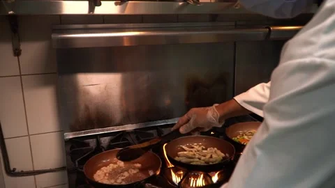 Sautéing Ingredients in a Kitchen Stock Footage 319207236