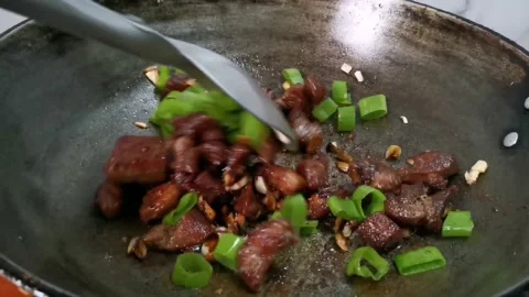 Sauteing Pork Cutlets with Leeks in a Frying Pan Stock Footage 157676449