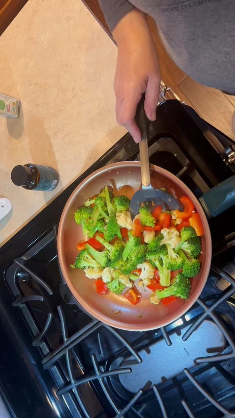 Sauteing vegetables on the stove Stock Footage 303682554