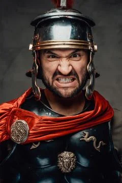 Savage and anrgy roman warrior with armour Stock Photos