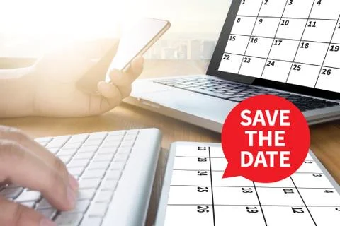SAVE THE DATE message on hand holding to touch a phone, top view, table com.. Foto stock