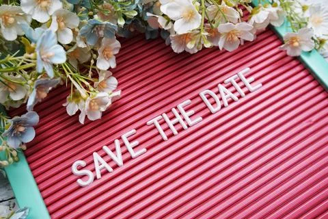 Save the Date text on Letter Board with flower decoration Stock Photos