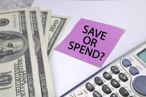 Save or spend wording with usd bank note and calculator with white background Stock Photos