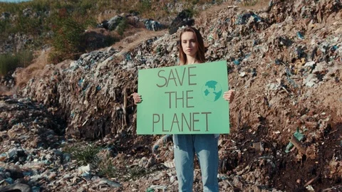 Save the planet. Nice smart young woman looking on camera holding eco poster Stock Footage 113818333