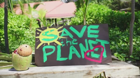 Save the Planet poster close-up in the tropics. Stock Footage 155797522