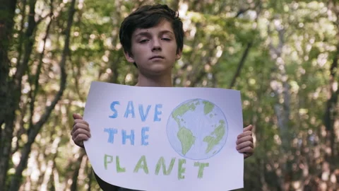Save the planet poster protest boy holding in front of him in forest Stock Footage 139281268
