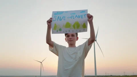 Save the planet poster protest boy holding in front of him on wind turbines Video stock 157813308