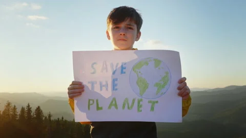 Save the planet poster protest boy holding in front of in mountains Stock Footage 208941800