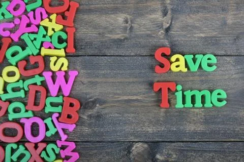 Save Time on wooden table Fotos Stock