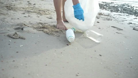 Save water. Volunteer pick up trash garbage at the beach and plastic bottle.. Stock Footage 336326733