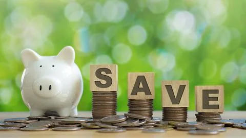 SAVE wooden text block on stack of coin and piggy bank with green backgound.. Stock Photos