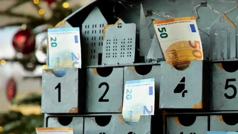 Saving for Christmas.euro notes in metal advent calendar. December expense 動画素材 345264906