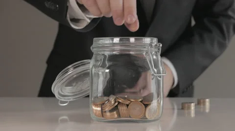 Saving Coins in Jar Video stock 47315304