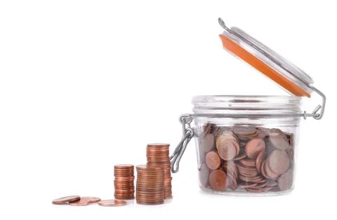 Saving coins in a jar Foto stock