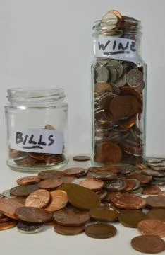 Saving up with coins in jars Stock Photos