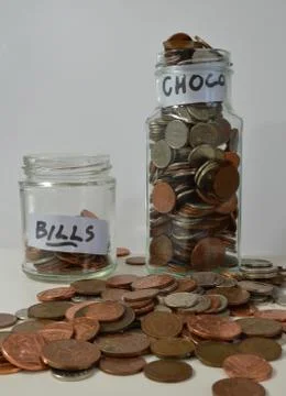Saving up with coins in jars Stock Photos