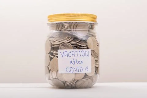 Saving Coins, Saving Money. Save Coin in Jar for vacation after COVID-19 Stock Photos