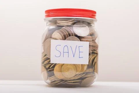 Saving Coins, Saving Money. Save Coin in Jar for vacation after COVID-19 Stock Photos