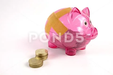 SAVING DETERIORATE CONCEPT. Red piggy bank with bandage and small stack of c Stock Photos