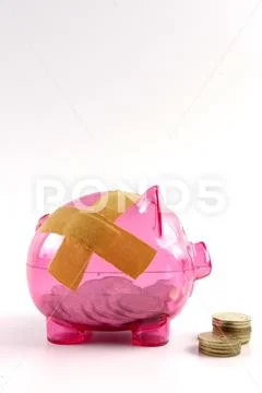 SAVING DETERIORATE CONCEPT. Red piggy bank with bandage and small stack of c Stock Photos