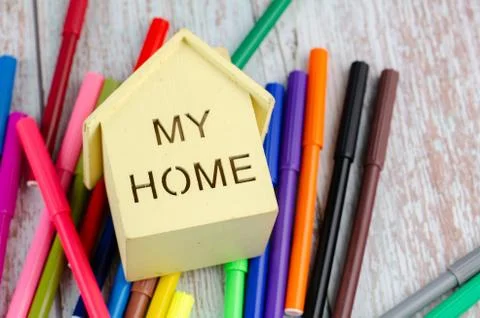Saving for education or back to school concept, home replica and colorful mar Stock Photos