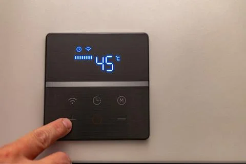Saving electricity, setting the temperature in the water heater Stock Photos