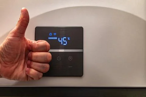 Saving electricity, setting the temperature in the water heater Stock Photos