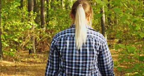 Saving the forest from garbage. A female volunteer collects plastic and glass Stock Footage 253060374