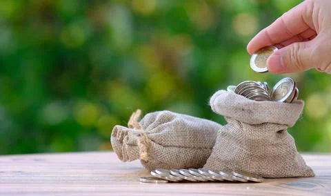 Saving money concept and stacking coins on table background business growth.. Stock Photos