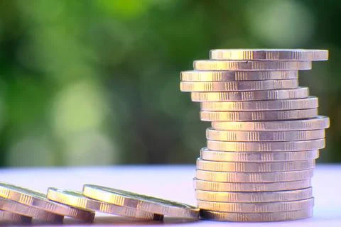 Saving money concept stacking coins on table background Stock Photos