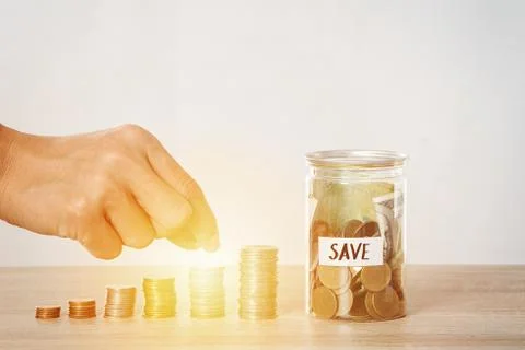 Saving money,Hand put coin stack on money staircase ,Business growing and saving Stock Photos