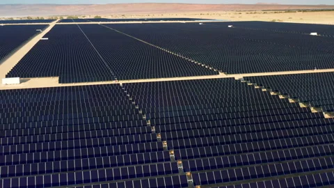 Saving planet concept. Huge fields with solar power panels. 4K aerial 動画素材 145421442