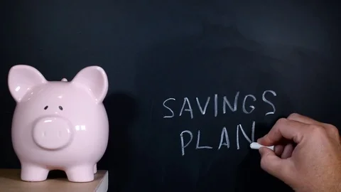 Savings Plan hand written on a chalk board by a financial planner Stock Footage 81801406