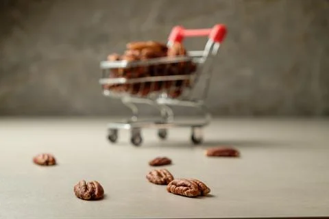 Savoring pecan nuts in a rustic kitchen with a playful cart Stock Photos