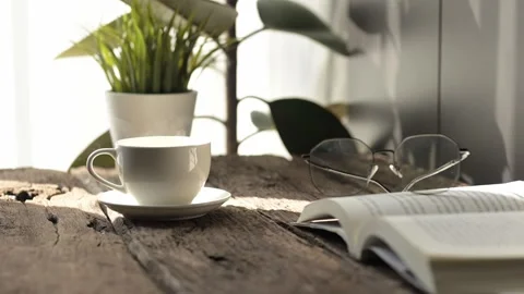Savoring slow motion hot coffee and espresso moments in a cozy reading nook with Stock Footage 296997822