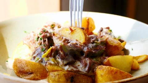 A Savory and Delicious Dish Featuring Potatoes in a Rich, Flavorful Sauce That Stock Footage 307996688