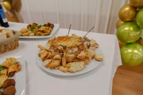 A savory assortment of appetizers, bread, mini pies, croquettes, and cheese Stock Photos