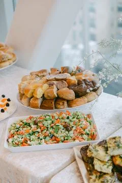 Savory buffet display featuring fresh vegetables, bread rolls, and a vibrant Stock Photos