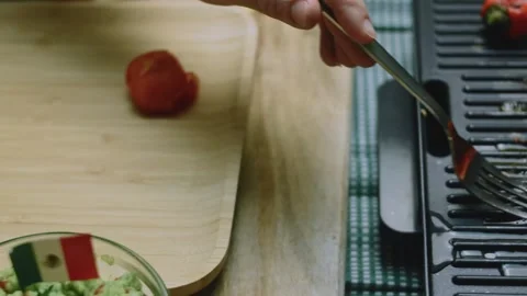 Savory culinary view of lifting roasted tomatoes from the grill Stock Footage 342152701