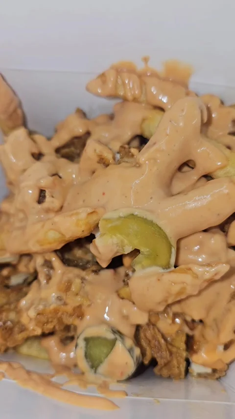 Savory dish featuring loaded chopped crispy chicken, french fries, Stock-Footage 321701024