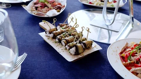 Savory eggplant rolls stuffed with melting cheese, sprinkled with chopped nuts Stock Footage 336429171