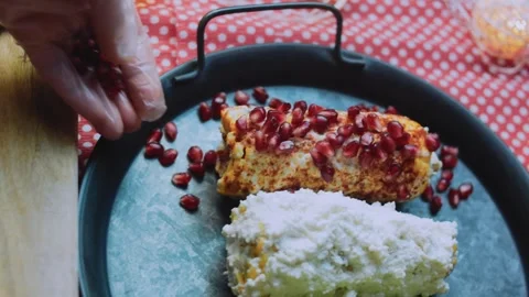 Savory food study: adding pomegranate seeds to elote Stock Footage 342172063