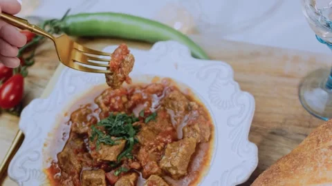 Savory garnished dish view: showing tender beef in tomato sauce Video stock 342199946