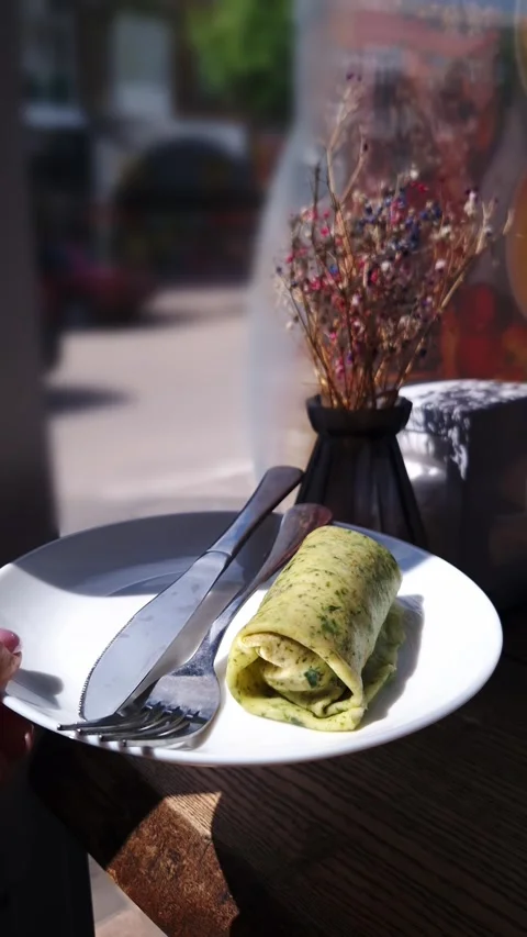 Savory Green Spinach Pancake Roll with Fork and Knife on Wooden Table Stock Footage 339075300