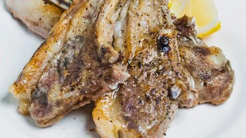 Savory grilled lamb chops with a side of potatoes Stock Photos
