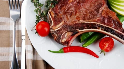 Savory : grilled spare rib on white dish with pepper and tomato Stock Footage